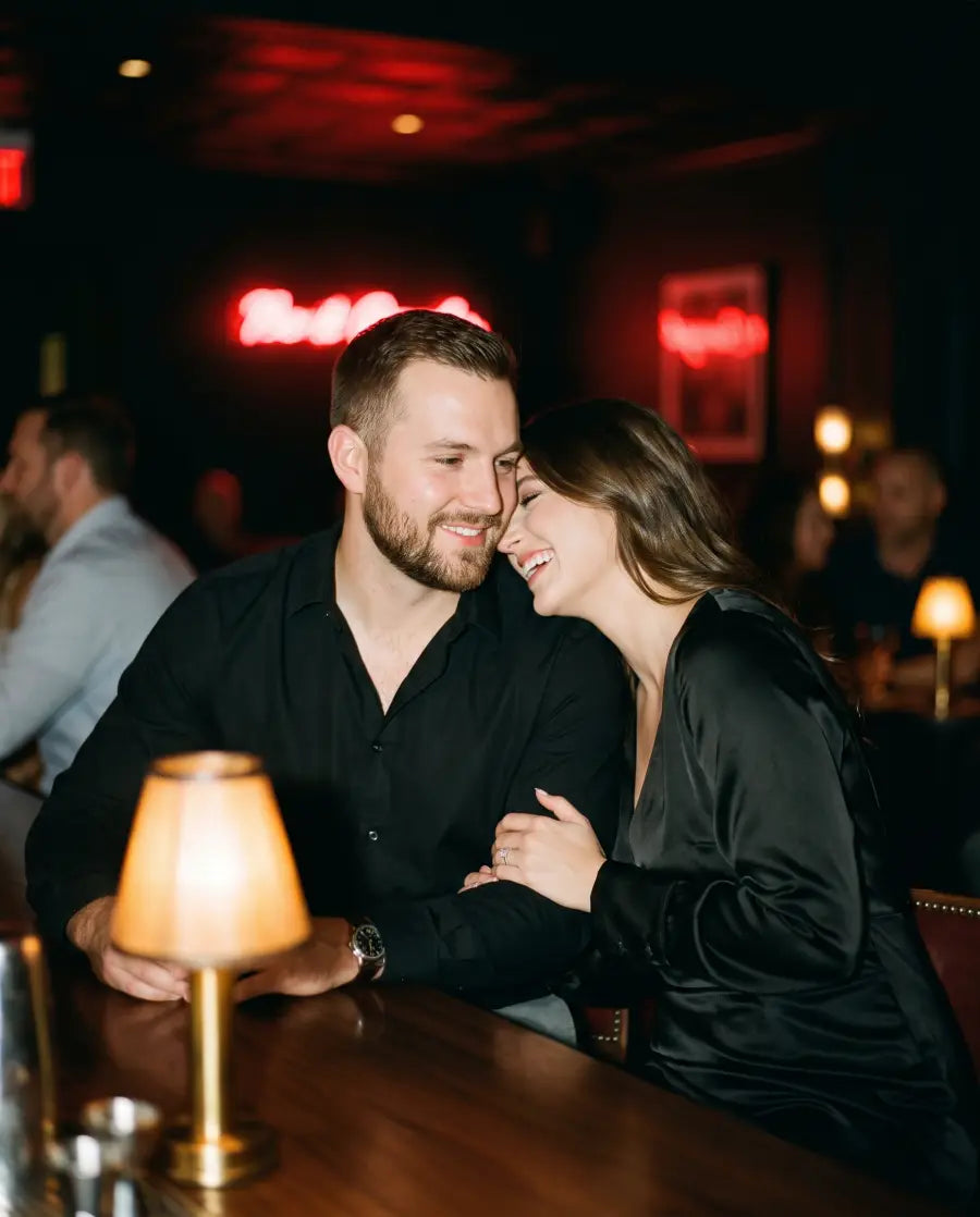 Couple laughing at a dim bar